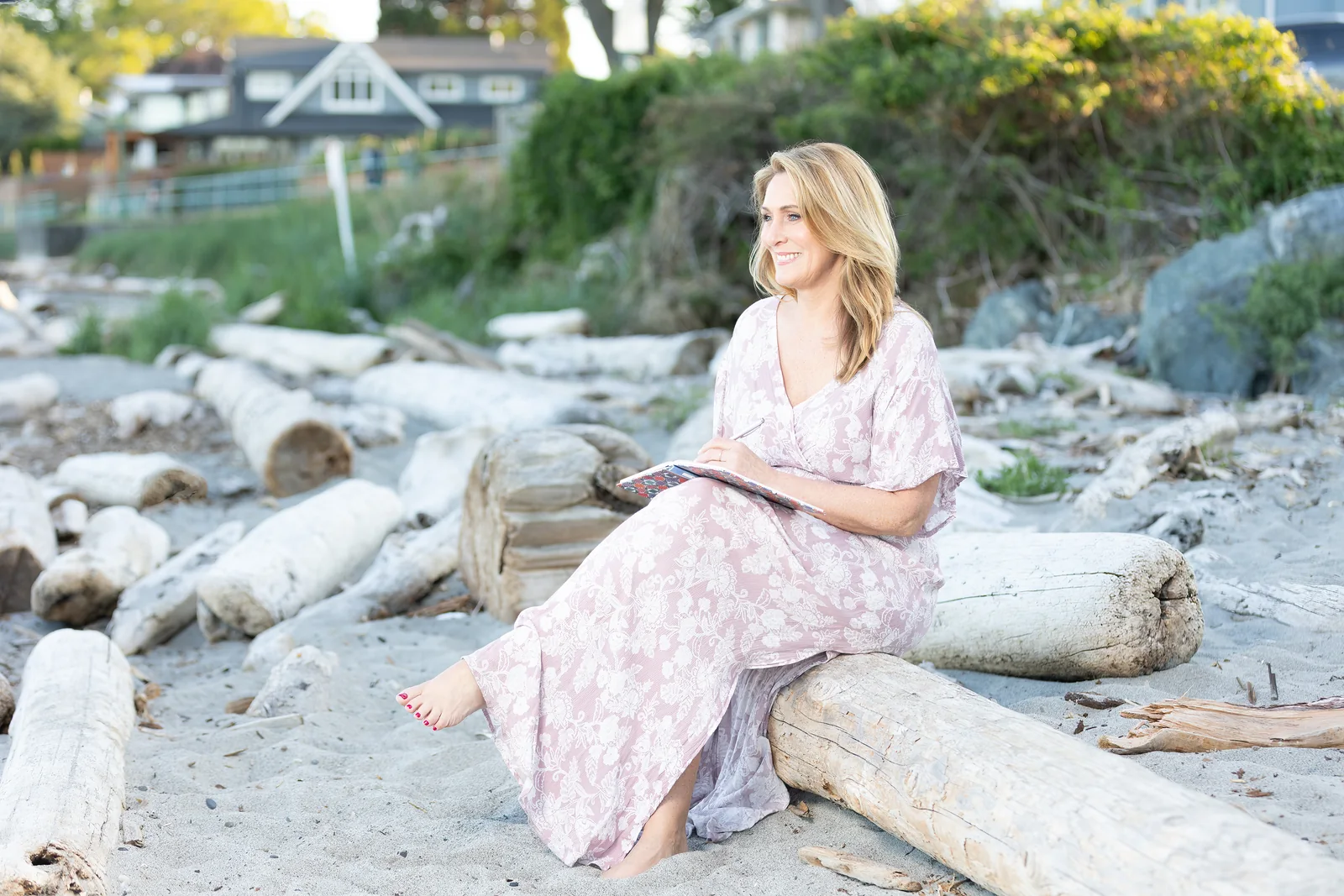 Dawn Cox in a pink dress on the Victoria shoreline